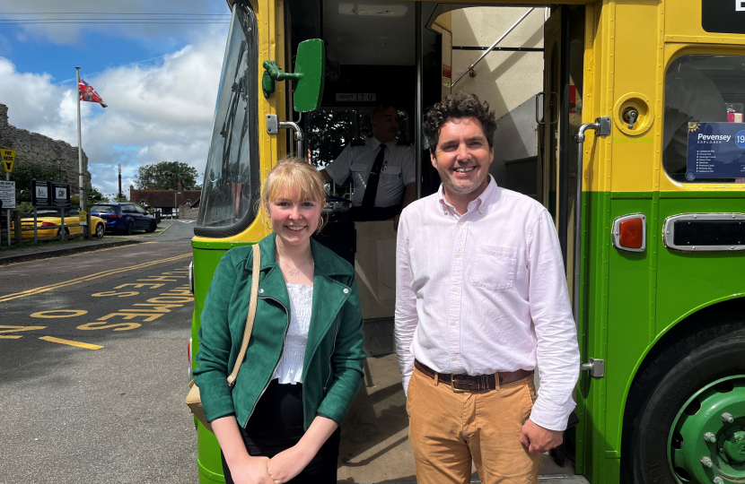 Photo of Huw and Sarah in front of bus